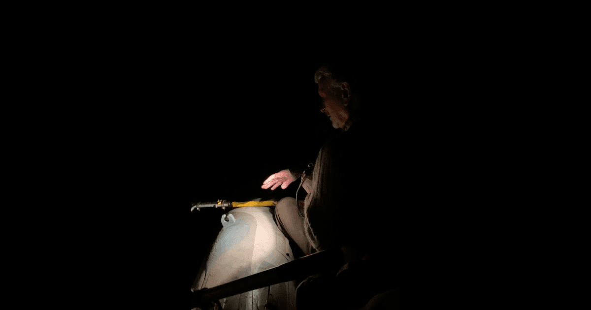 Archive photograph: Stan Orchard spends many of his summer nights like this: sitting in an inflatable dinghy in the dark, hunting for invasive bullfrogs. (📸 Zoë Ducklow/The Westshore)