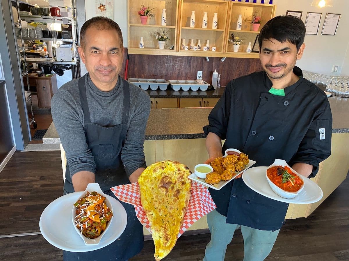 Archive photograph: Brothers, chefs, and business owners, Ram and Somnath Bhatt, show off some of their favourite dishes: (L-R) vegetable jalfrezi, garlic naan, vegetable pakora, and chicken tikka masala. Yum! (📸 Zoë Ducklow/The Westshore)