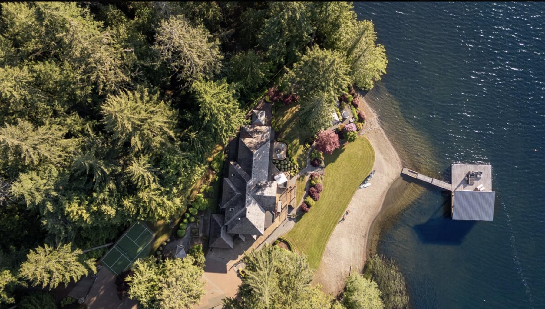 Aerial view of Shawnigan Retreats: two houses, private beach, and dock on Shawnigan Lake